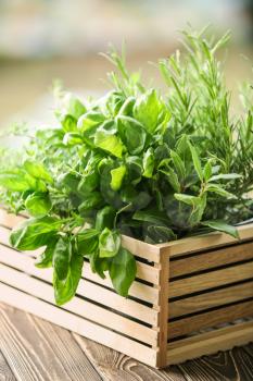 Wooden crate with fresh aromatic herbs outdoors�