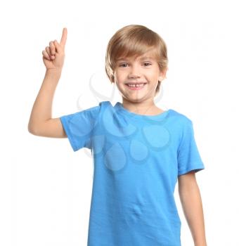 Little boy in t-shirt and with raised index finger on white background�