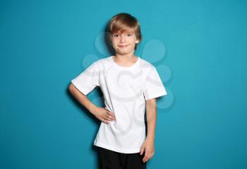 Little boy in t-shirt on color background�