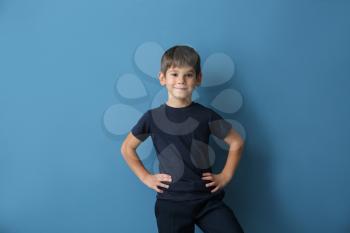 Cute little boy in t-shirt on color background�