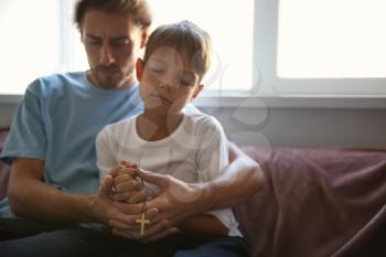 Father with son praying at home�