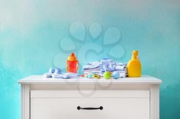Baby clothes and accessories on dresser�
