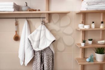 White terry towels, bathrobe and cosmetics in bathroom�