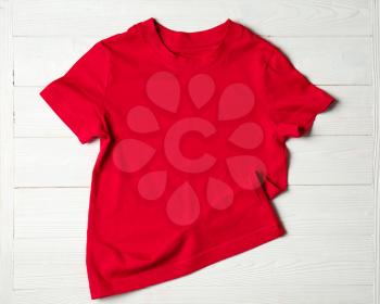 Child t-shirt on white wooden background�