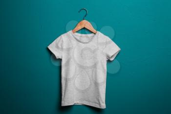 Child t-shirt with hanger on color background�