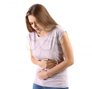 Young woman suffering from abdominal pain on white background�