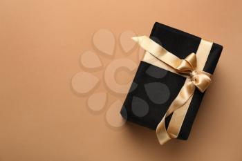Beautiful gift box on color background�