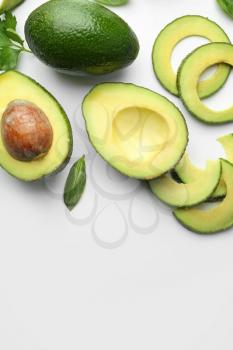 Composition with cut avocado on white background�