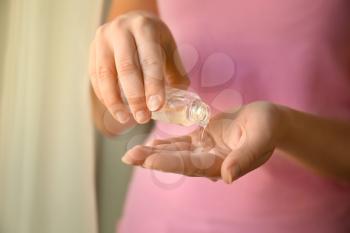 Woman using antibacterial hand gel, closeup�