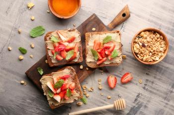 Tasty toasts with strawberry on table�