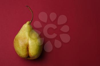 Fresh juicy pear on color background. Erotic concept�