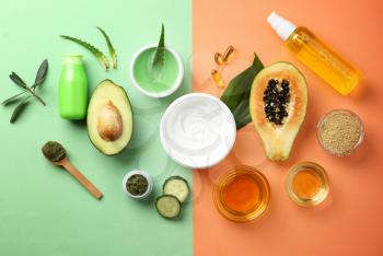 Flat lay composition with fruits and natural cosmetics on color background�