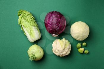 Fresh cabbages on color background, flat lay�