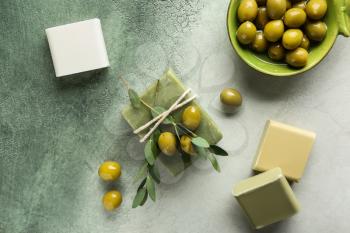Soap bars with olives on color table�