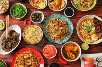 Assortment of Chinese food on wooden table�