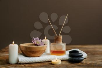 Beautiful spa composition with burning candles and sea salt on wooden table�