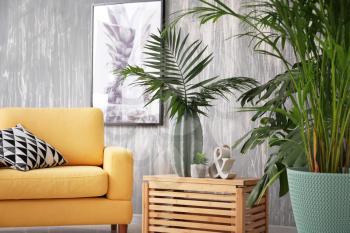 Green tropical plants in interior of living room�