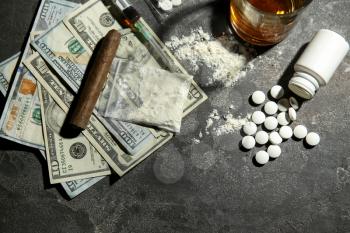 Drugs, alcohol and money on grey background. Concept of addiction�