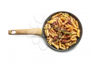 Tasty pasta with meat and spices in pan on white background�