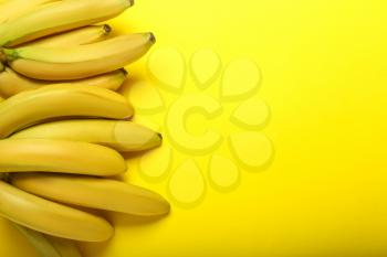 Ripe sweet bananas on color background�