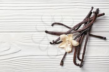 Aromatic vanilla sticks on white wooden background�