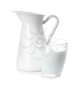 Jug and glass of fresh milk on white background�