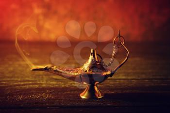 Aladdin lamp of wishes on wooden table�