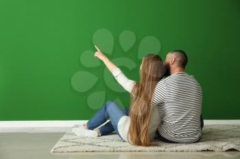 Young couple thinking about design of their new flat�