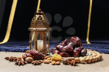 Composition with tasty dates and Muslim lamp on table�