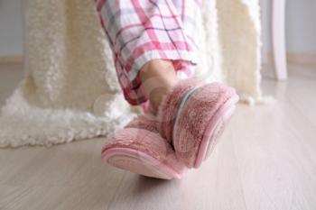Young woman in slippers at home�