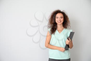 Portrait of young businesswoman on light background�