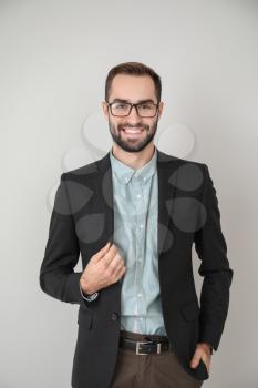 Portrait of young businessman on light background�