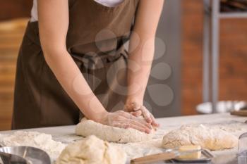 Female baker making dough in kitchen�