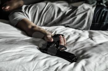 Man with gun after committing suicide in bedroom�