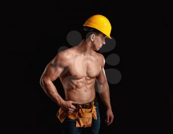 Muscular worker on dark background�