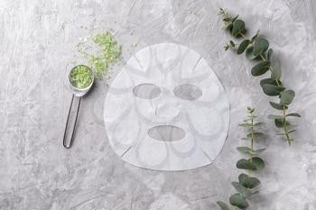Sheet facial mask with sea salt on grey background�