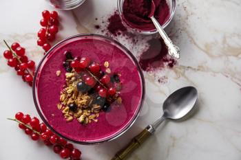 Bowl with tasty acai smoothie on light table�