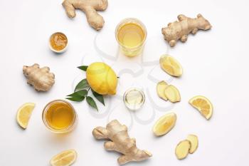 Glasses of healthy drink with ginger and lemon on white background�