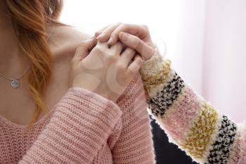 Young woman comforting her friend at home�