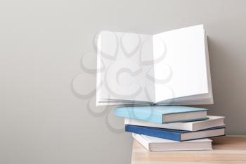 Many books on table against light background�