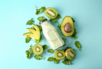 Composition with bottle of smoothie and ingredients on color background�