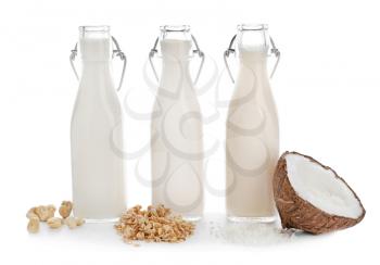 Assortment of tasty vegan milk on white background�