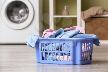 Basket with dirty laundry on floor in bathroom�