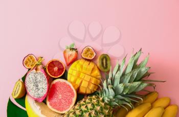 Assortment of exotic fruits on color background�