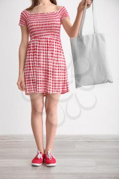 Young woman with eco bag indoors�