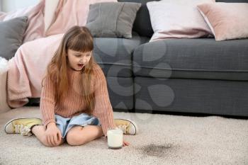Cute little girl after spilling milk on carpet�