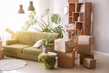 Furniture with moving boxes and belongings in room�