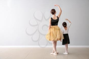 Little ballerina training with coach in dance studio�