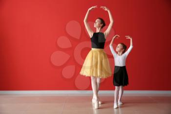 Little ballerina training with coach in dance studio�