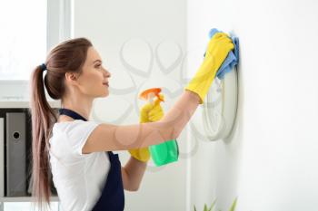 Female janitor cleaning office�